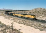 Union Pacific C40-8W #9379 (with SD60M's 6255 & 6311), in full dynamic braking, begins its slow descent down Cima Hill with a loaded coal train 